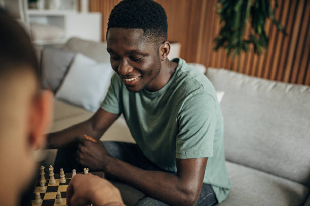 istock Male friends playing chess 1563080173