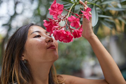 Kazakh girl with beautiful flowers on a plant