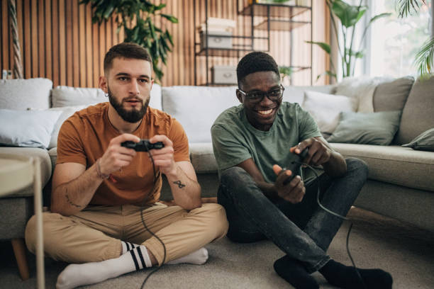 istock Male friends playing video game 1563082856