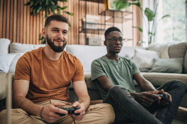 istock Male friends playing video game 1563083381