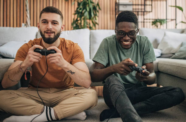 istock Male friends playing video game 1563083911