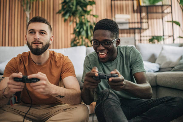 istock Male friends playing video game 1563084441