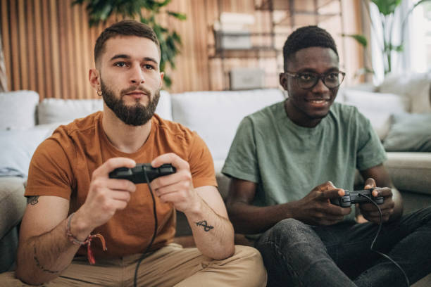 istock Male friends playing video game 1563085458