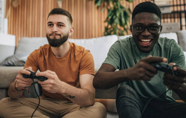 istock Male friends playing video game 1563085985