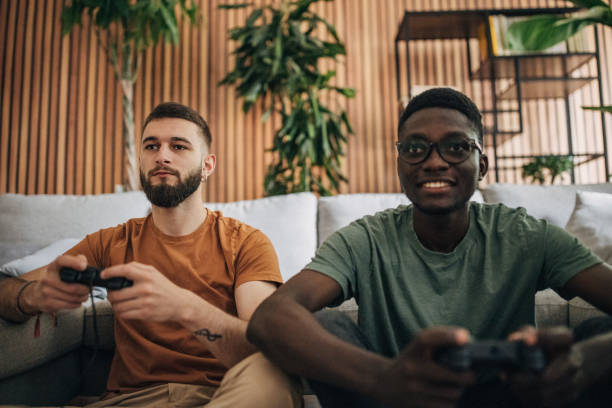istock Male friends playing video game 1563088188