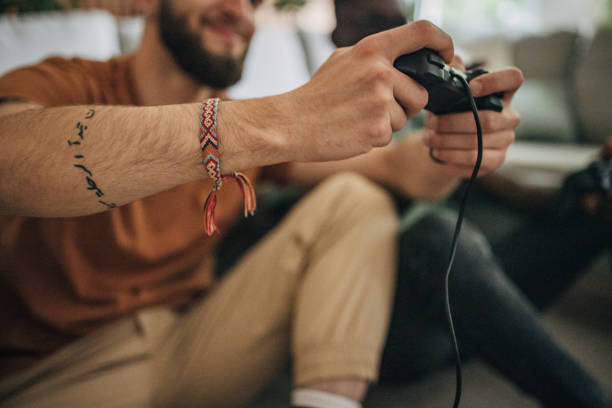 istock Male friends playing video game 1563088756