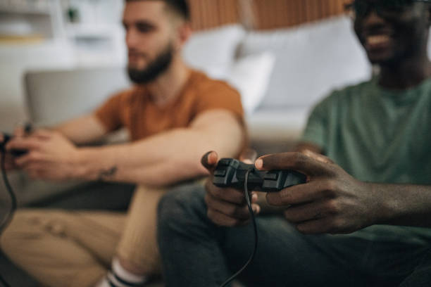 istock Male friends playing video game 1563089308