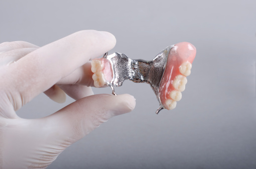 Dental Technician's Holding Finished Denture