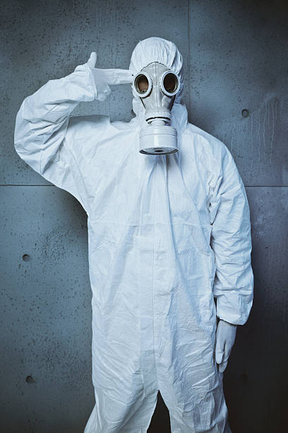 istock Hopeless man in gas mask shooting his head 156311467