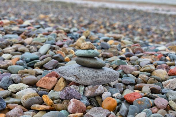 istock Stacked stones on a shingle beach 1563127754