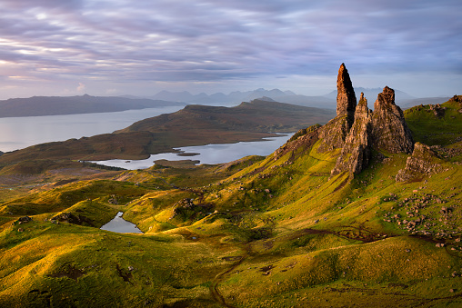 An early morning sunrise looking towards the pinnacles of The Old Man of Storr with Raasay in the background. This amazing viewpoint is one of Scotlands most famous and is visited by tourists from all over the world!
