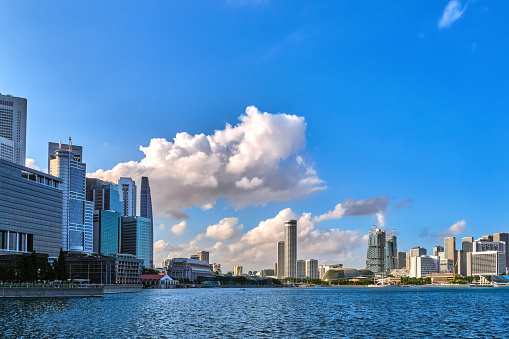 Skyline of Singapore in Marina bay. CBD buildings, Fullerton hotel, Raffles CCC, Esplanade Theaters, South Beach residence, hotels, shopping malls and residences. Bright sunny day, sunshine, beautiful clouds. Modern and state-of-the-art architecture.