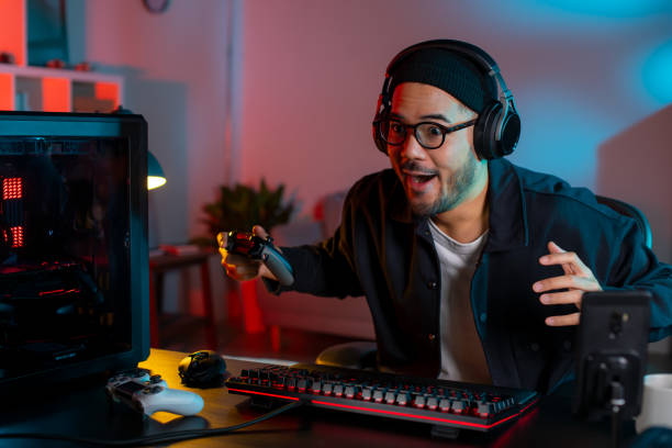 istock Happy young Asian man playing a video game 1563163797