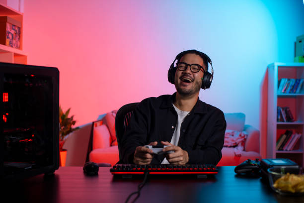 istock Happy young Asian man playing a video game 1563163850