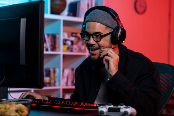 istock Happy young Asian man playing a video game 1563163869