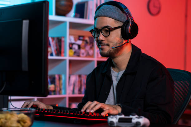 istock Happy young Asian man playing a video game 1563163875
