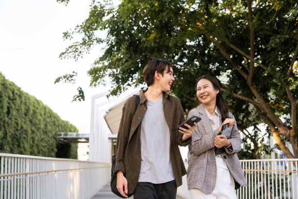 istock Two young coworkers relaxing after business successfully. 1563164498