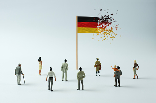 German flag disintegrating (the concept of economic crisis, pandemic, internal opposition, terrorism, refugees, etc.)