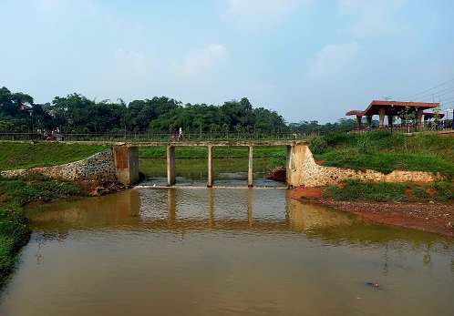 Jakarta, Indonesia, 25 June 2023: View of the bridge in the Pondok Ranggon River Overflow Space (RLS) area, East Jakarta, apart from functioning as flood control, it also functions as a playground and recreation
