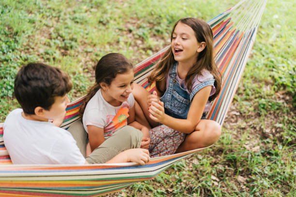 istock Children having fun smiling on a hammock 1563183369
