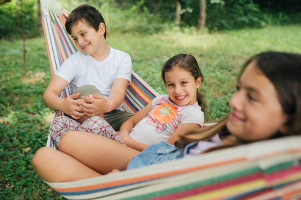 istock Children having fun smiling on a hammock 1563183895