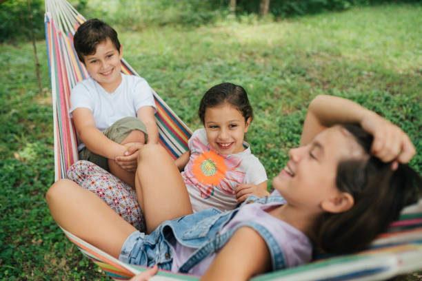 istock Children having fun smiling on a hammock 1563188866