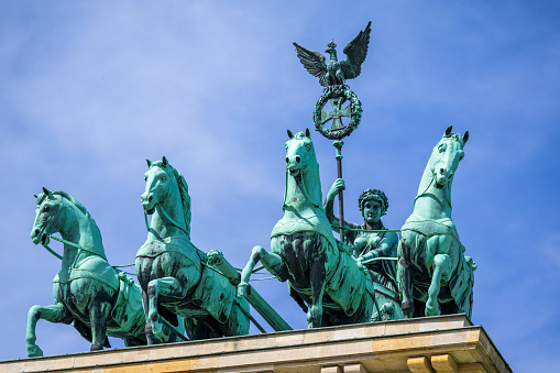 Berlin, Germany - May 31, 2023: The bronze sculpture Quadriga on top of the Brandenburg Gate in Berlin, Germany