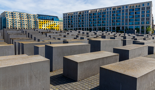 Berlin, Germany - November 1, 2021: View to the Holocaust Memorial in Berlin.  It commemorates  the mass murder of the Jews in the third reich. Designed by architect Peter Eisenman, exhibition opened in 2005.