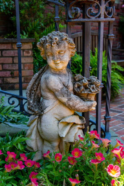 flowers surrounding a garden statue