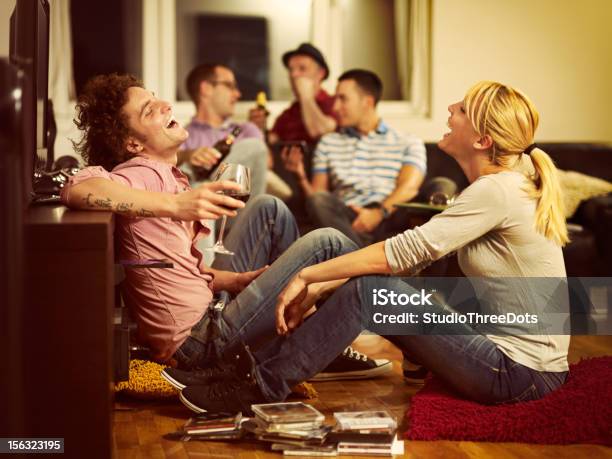 Young Couple Sitting On The Floor And Watching Tv Stock Photo - Download Image Now - Party - Social Event, Friendship, Domestic Life