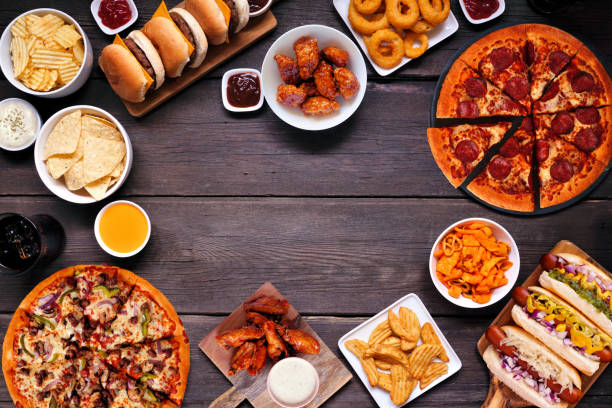 istock Junk food frame over a dark wood banner background 1563245794