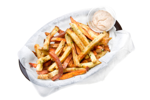Gourmet Garlic Seasoned French Fries Isolated on white with sea salt