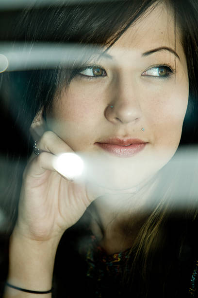 istock Beautiful Young Woman Looking Through Window 156324915