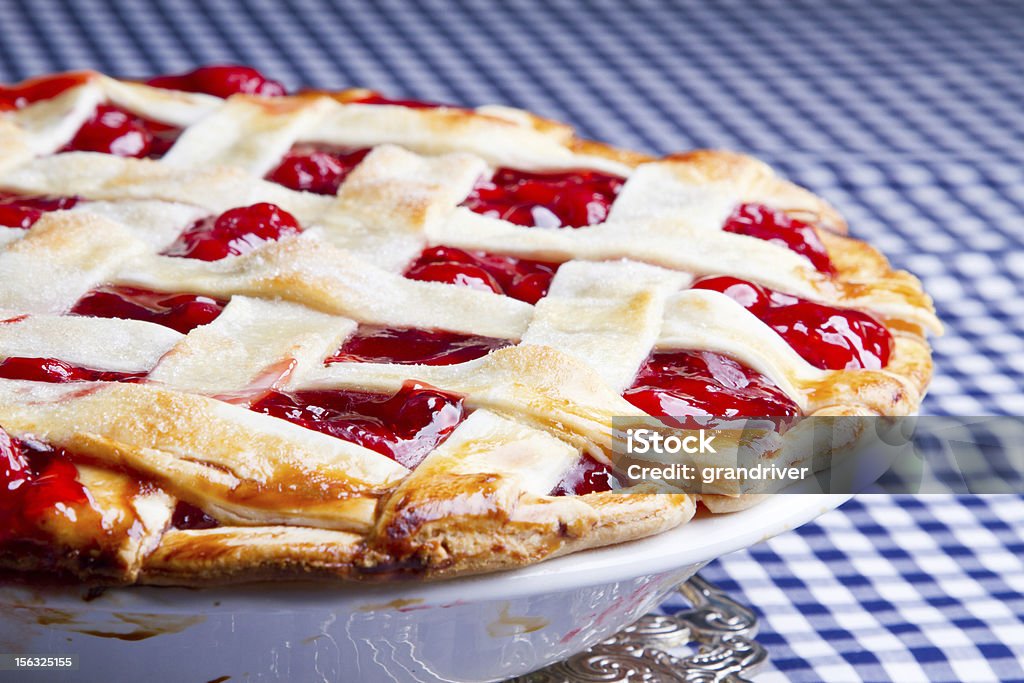 Homemade Cherry Pie on Blue Gingham Checked Tablecloth Homemade Cherry Pie on Blue Gingham Checked Tablecloth fresh from the oven Baked Stock Photo