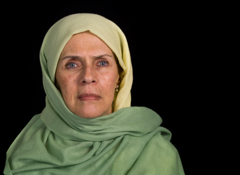 Serious senior muslim woman on black background (this picture have been shot with a Hasselblad HD3 II 31 megapixels) 