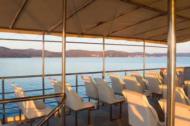 Empty passengers seats on a ferry boat in Dalmatia during sunrise, Zadar region, Adriatic sea