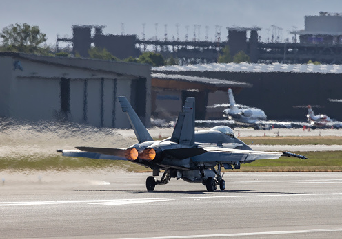 A F-18 Hornet military jet on takeoff roll at Portland International Airport.