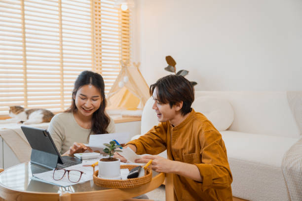 Couple doing home finances together at home.