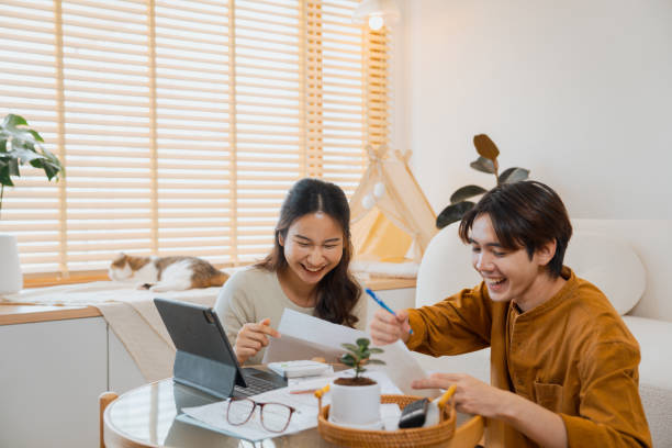 istock Young couple using a digital tablet to plan family budget. 1563268797