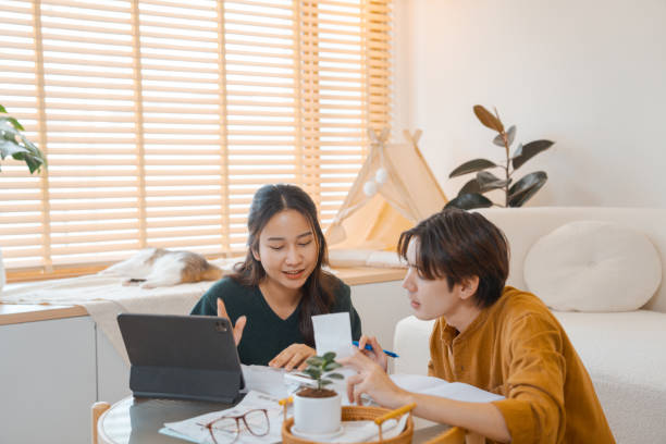 istock Young couple using a digital tablet to plan family budget. 1563268822