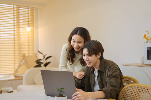 istock Boyfriend makes an online booking at home. 1563269946