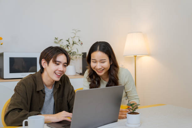 istock Boyfriend makes an online booking at home. 1563269957