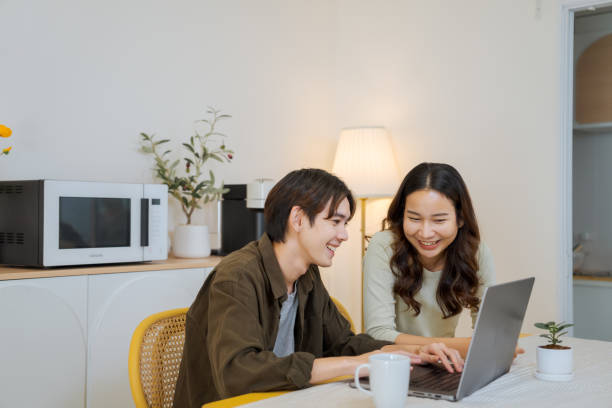 istock Boyfriend makes an online booking at home. 1563269967