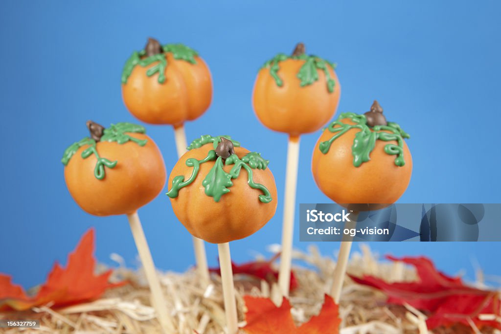 Pumpkin cake pops Mini cakes shaped like pumpkins dipped in colored chocolate and decorated with leaves Cake Pop Stock Photo