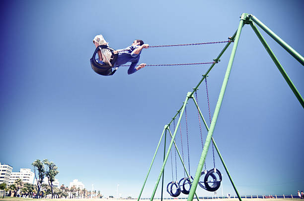 Free Running Parkour Cape Town Free Runner performing a big aerial stunt in Cape Town Sea Point park swings. South Africa. parkour sequence stock pictures, royalty-free photos & images