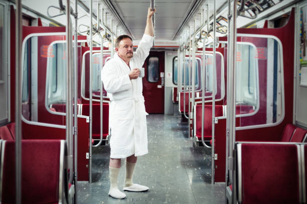 Early commuter on the train Early commuter wearing bathrobe and slippers on the underground train. passenger train photos stock pictures, royalty-free photos & images