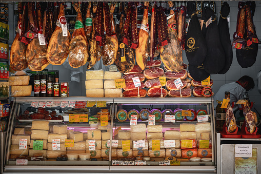 Cadiz, Spain - Apr 9, 2019: Market Stall with pieces of Jamon iberico (Iberian Ham) and Cheese - Cadiz, Andalusia, Spain