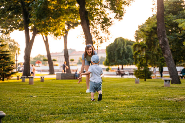 istock Young Mother Playing With Her Son In The Park 1563332032