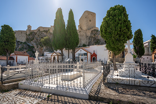 Olvera, Spain - May 12, 2019: Parish Cemetery and Olvera Castle Tower - Olvera, Andalusia, Spain