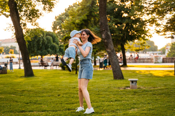 istock Young Mother Playing With Her Son In The Park 1563335238